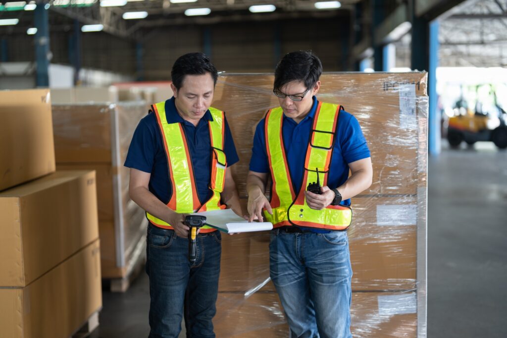 2 man working in the large storage warehouse scan bar code