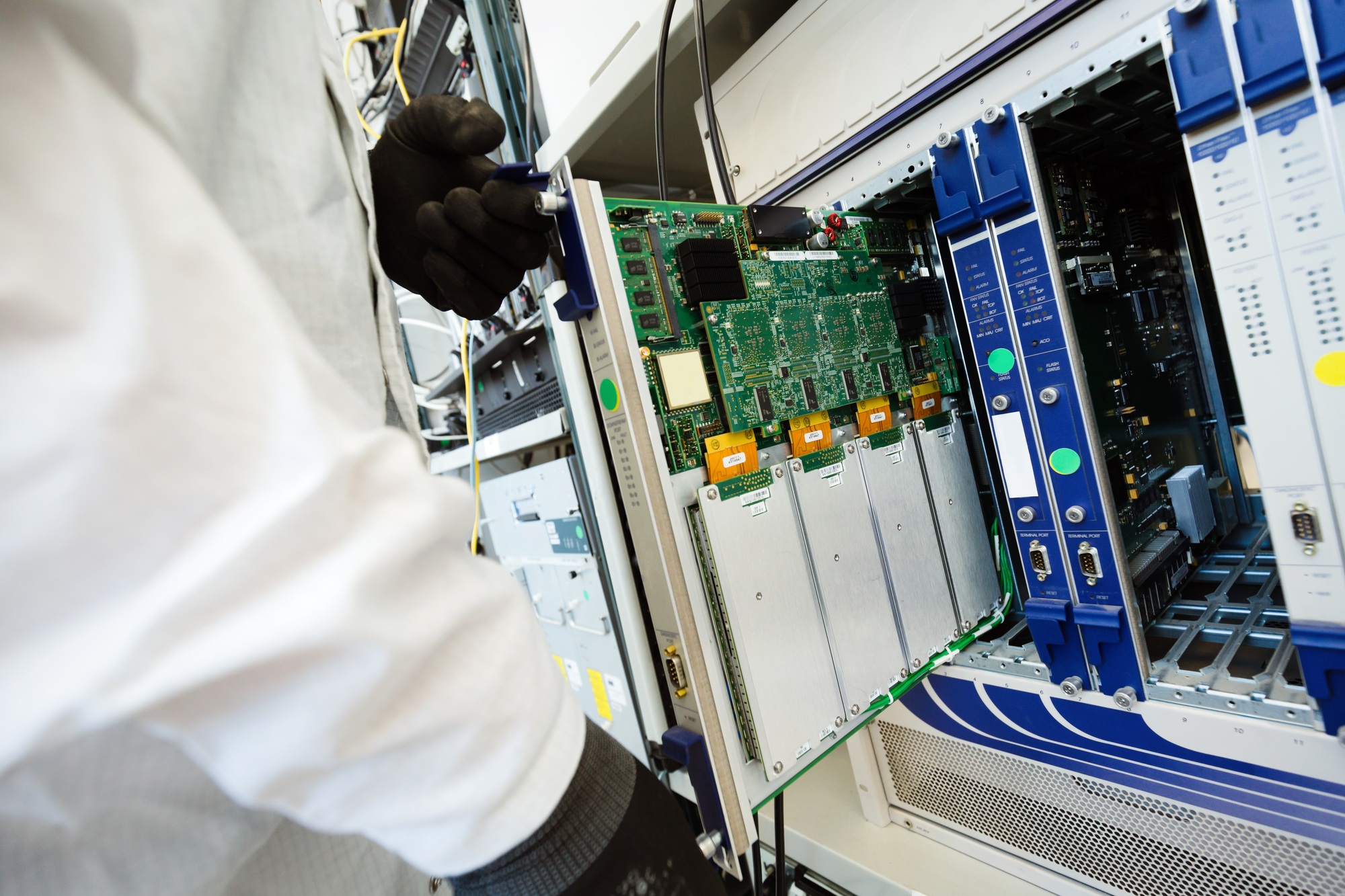 Picture of technician repairing cmts networking cards