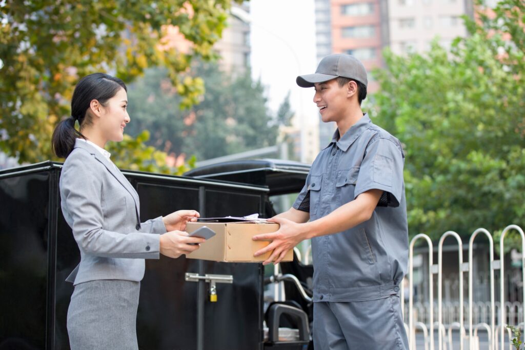 Young woman getting a package from delivery person